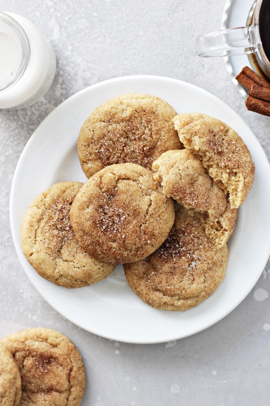 A white plate filled with Dairy Free Snickerdoodles with coffee to the side.