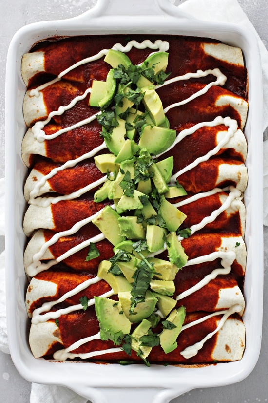 A white baking dish filled with Dairy Free Enchiladas.