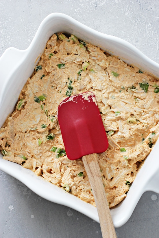 Unbaked dip spread in a baking dish.