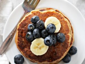 A stack of Dairy Free Banana Pancakes with a fork.