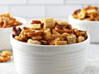 Three white bowls filled with Dairy Free Chex Mix.