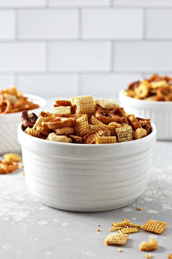 Three white bowls filled with Dairy Free Chex Mix.