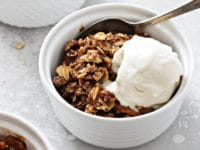 Three bowls of Gluten Free Dairy Free Apple Crisp topped with ice cream.