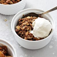 Three bowls of Gluten Free Dairy Free Apple Crisp topped with ice cream.