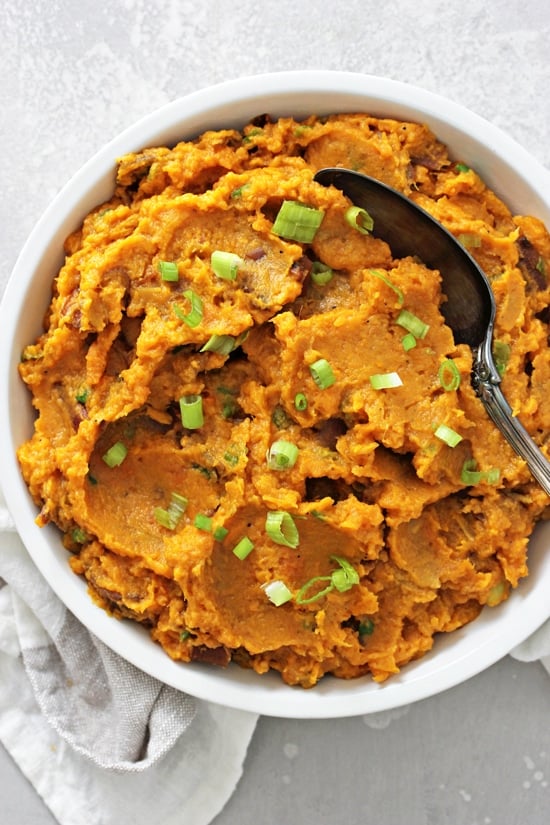A white bowl filled with Dairy Free Mashed Sweet Potatoes.