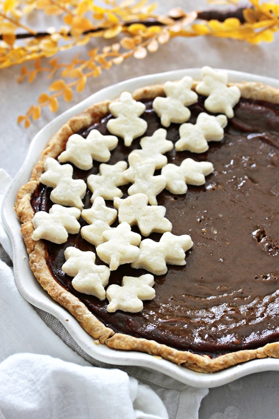 A Lactose Free Pumpkin Pie decorated with small leaves.