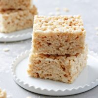 Two Dairy Free Rice Krispie Treats stacked on a plate.