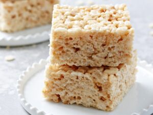 Two Dairy Free Rice Krispie Treats stacked on a plate.