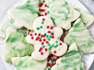 A white plate filled with decorated Dairy Free Sugar Cookies.