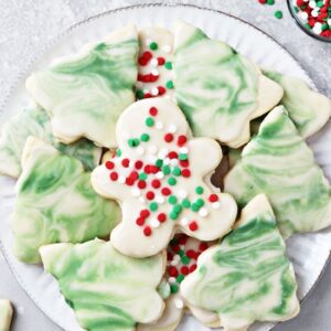 A white plate filled with decorated Dairy Free Sugar Cookies.