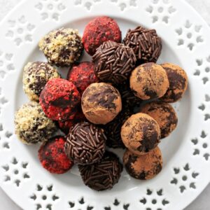 A white plate filled with Dairy Free Truffles.