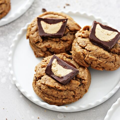Three Gluten Free Peanut Butter Cup Cookies on a white plate.