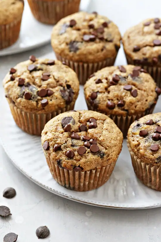 A white plate filled with Dairy Free Banana Chocolate Chip Muffins.