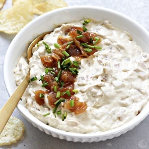 A bowl of Dairy Free French Onion Dip with a spoon.