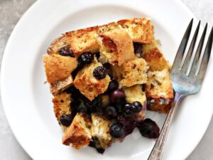 A serving of Dairy Free French Toast Casserole on a plate with a fork.