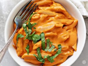 A bowl of Dairy Free Vodka Sauce with a fork in the dish.