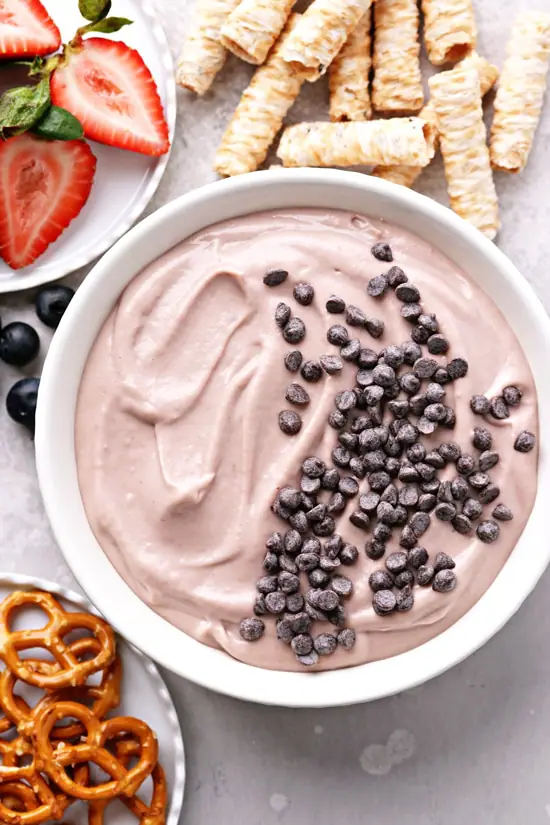 Dairy Free Fruit Dip in a serving bowl with fruit and pretzels.