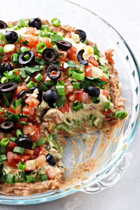 Dairy Free 7 Layer Dip with a section scooped out.