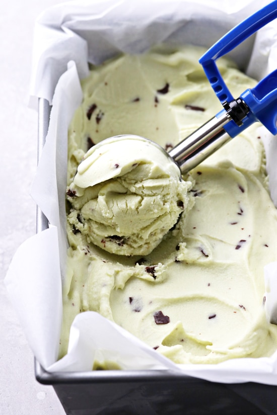 A container filled with Dairy Free Mint Chip Ice Cream.