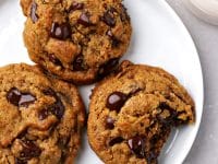 Three Dairy Free Pumpkin Chocolate Chip Cookies on a plate.