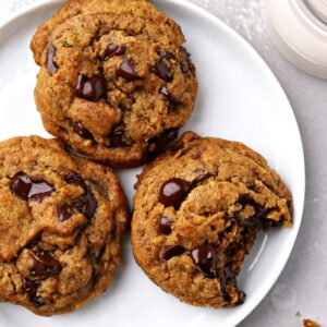 Three Dairy Free Pumpkin Chocolate Chip Cookies on a plate.