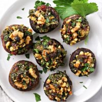 Several Dairy Free Stuffed Mushrooms on a white plate.