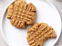Two Dairy Free Peanut Butter Cookies on a white plate.