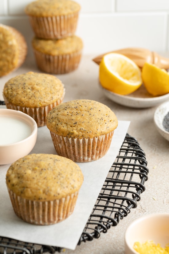 Several Non Dairy Lemon Poppy Seed Muffins on a cooling rack.