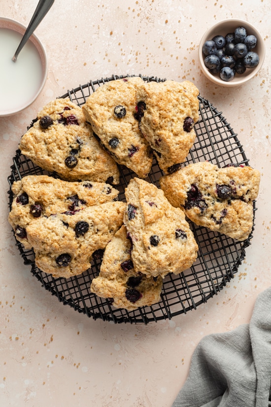 Several Coconut Oil Blueberry Scones on a cooling rack.