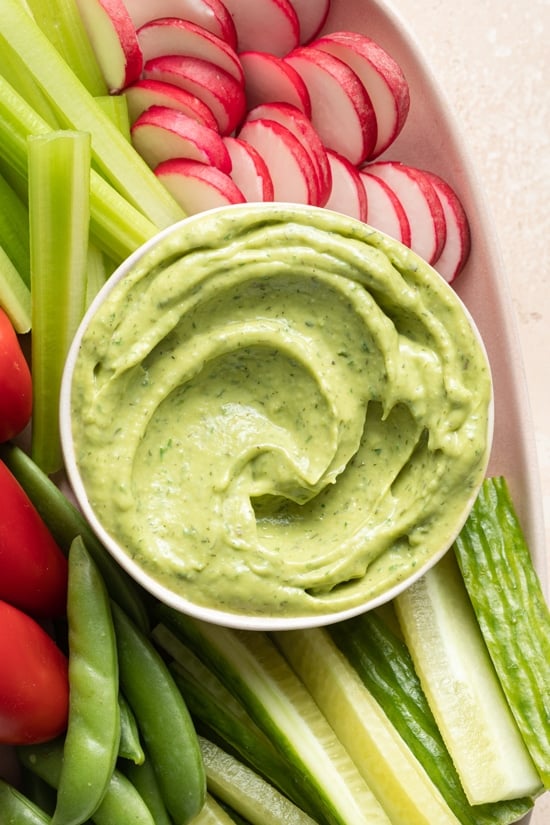 Dairy Free Avocado Dressing on a platter with veggies.