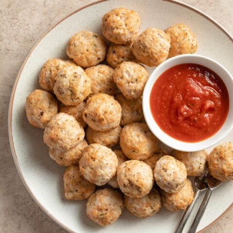 A platter with Dairy Free Chicken Meatballs and dipping sauce.