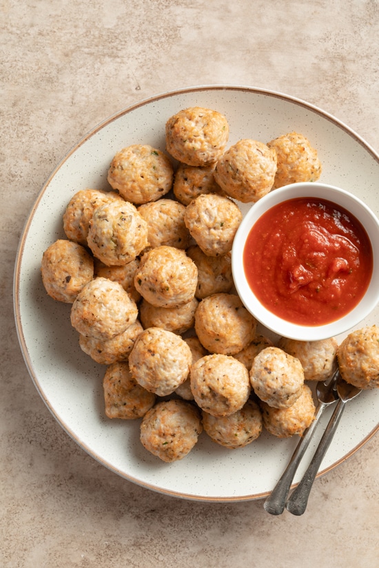 A platter with Dairy Free Chicken Meatballs and dipping sauce.