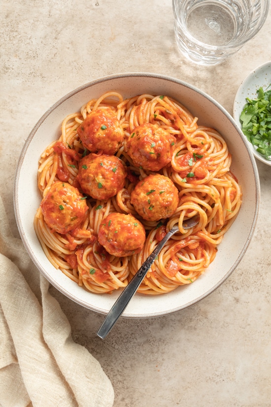 A bowl with spaghetti and Gluten Free Dairy Free Chicken Meatballs.