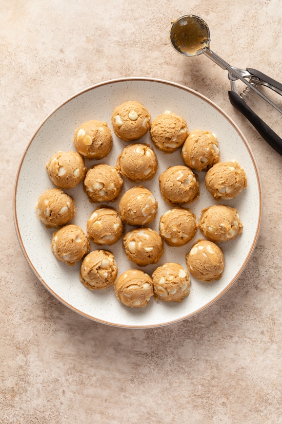 Cookie dough balls on a white plate.