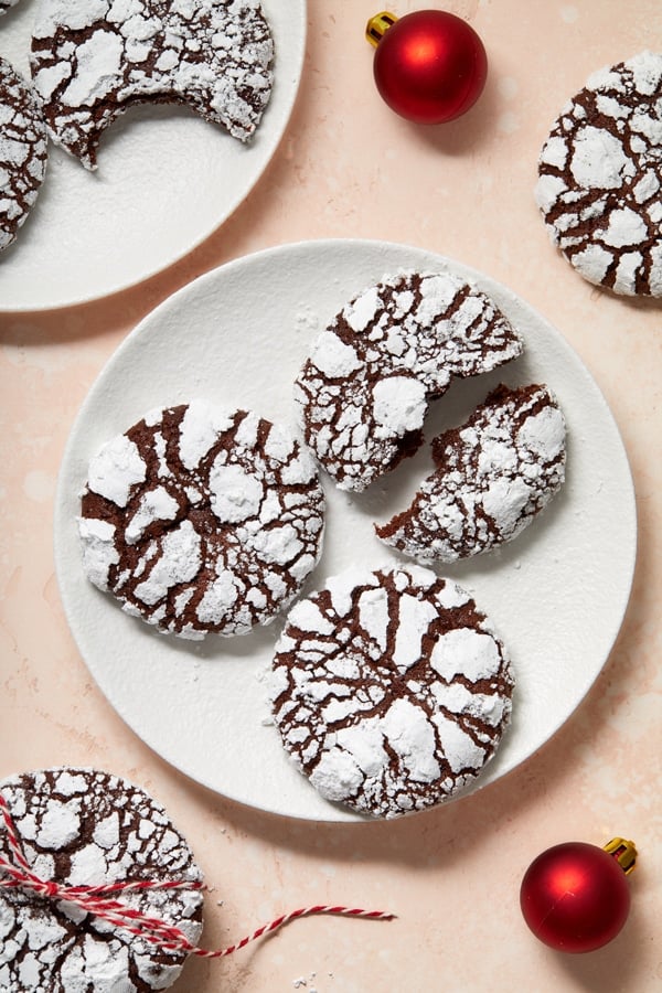 Dairy Free Chocolate Crinkle Cookies on plates with festive decorations.