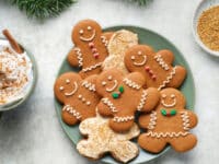 Dairy Free Gingerbread Men on a platter with holiday garland and a latte.