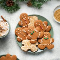 Dairy Free Gingerbread Men on a platter with holiday garland and a latte.