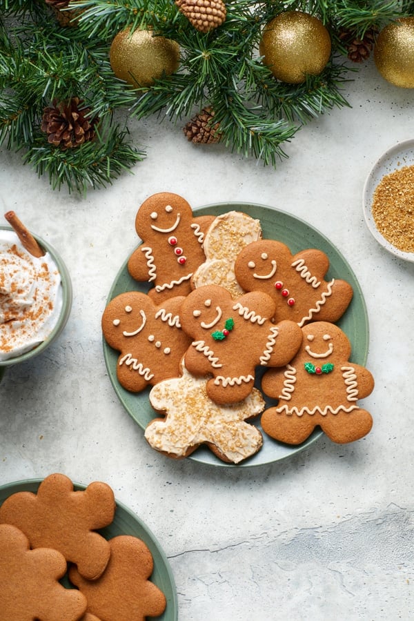 Dairy Free Gingerbread Men on a platter with holiday garland and a latte.