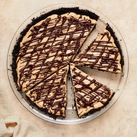 A Dairy Free Peanut Butter Pie partially sliced.