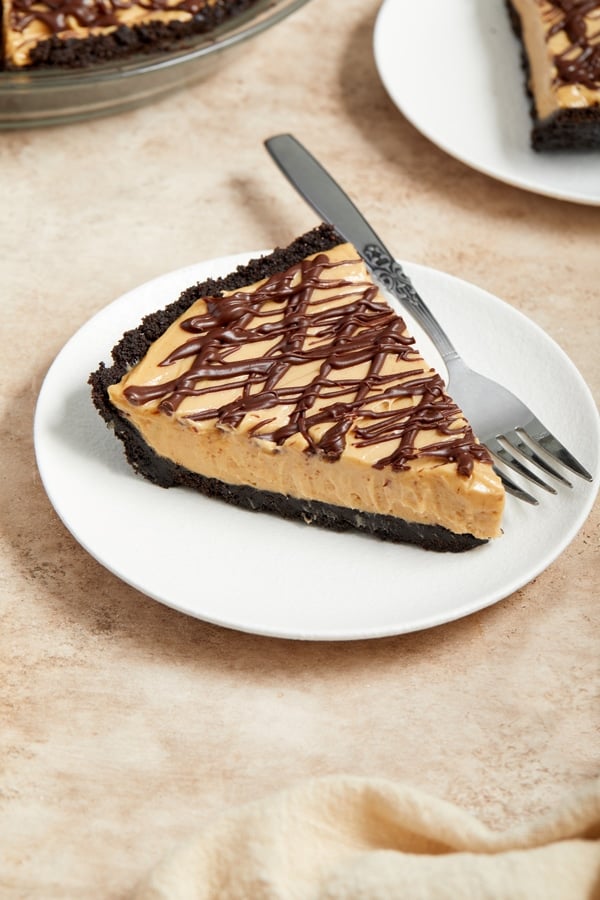 A slice of Non Dairy Peanut Butter Pie on a white plate.