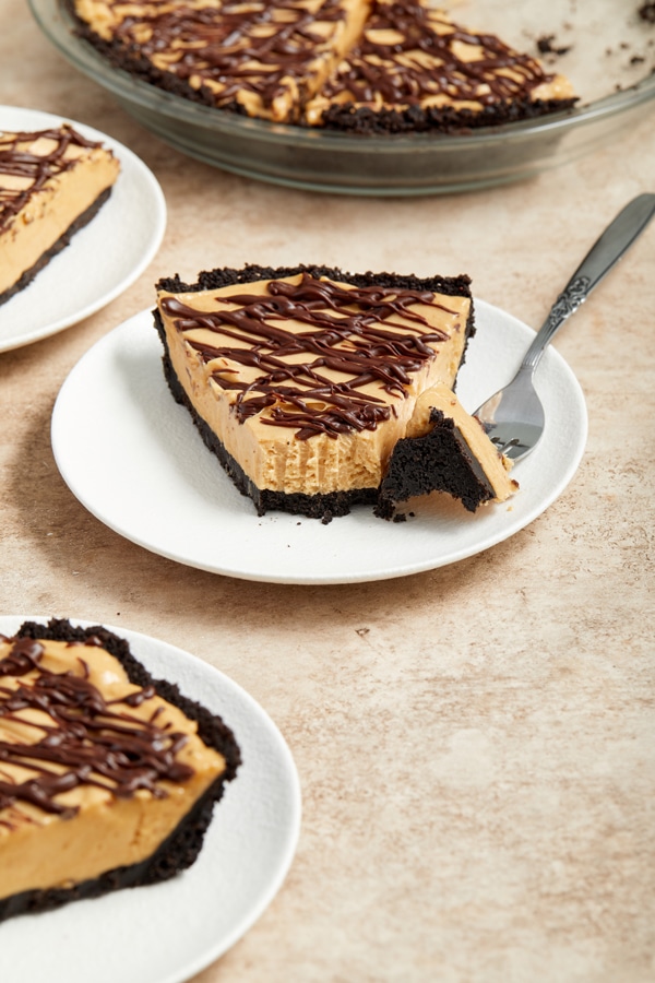 A slice of Dairy Free Chocolate Peanut Butter Pie with a bite taken out.