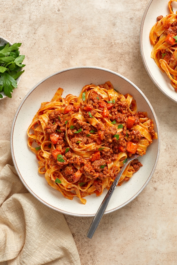 A bowl of Dairy Free Bolognese tossed with pasta.