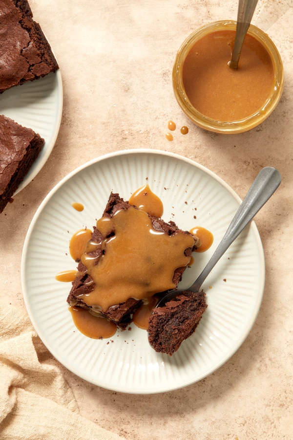 Milk Free Caramel Sauce drizzled over chocolate brownies.