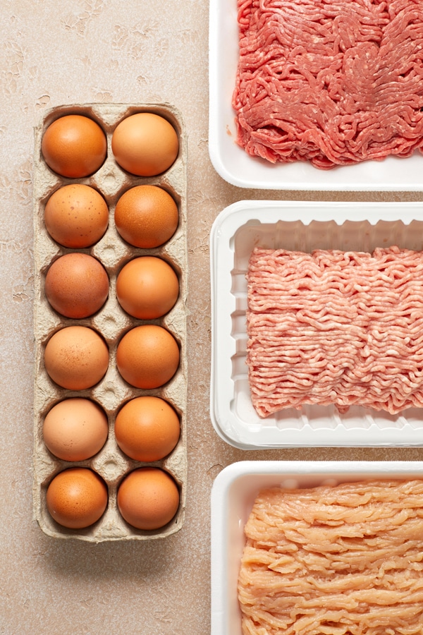 Eggs and ground meats on a surface.