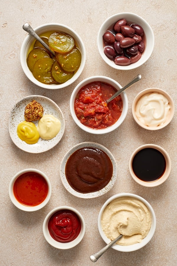 An array of condiments in small bowls. 