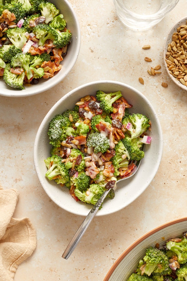 Dairy Free Broccoli Salad with Bacon in several small white bowls.