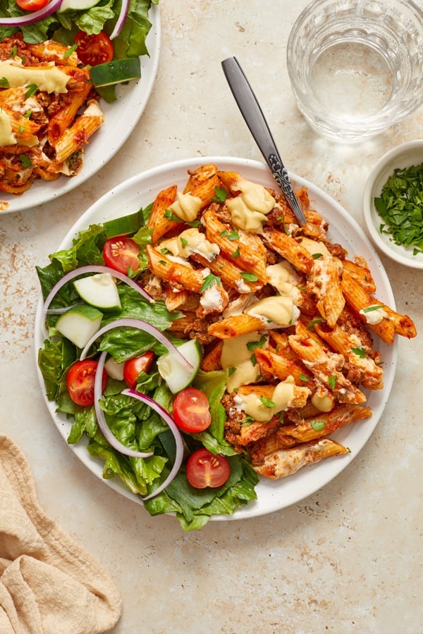 A plate filled with Dairy Free Baked Ziti and salad.