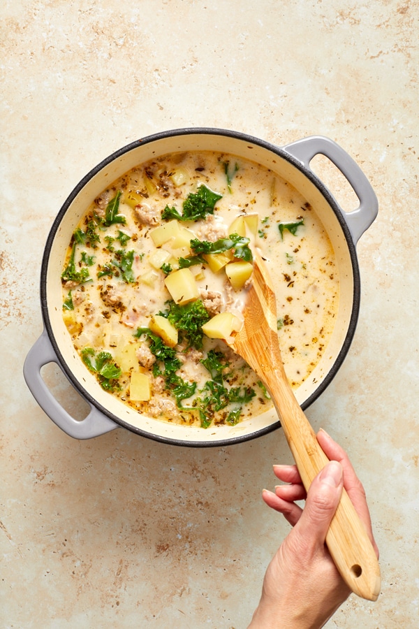 A dutch oven filled with No Dairy Zuppa Toscana.