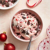 A pink bowl filled with Dairy Free Peppermint Ice Cream.