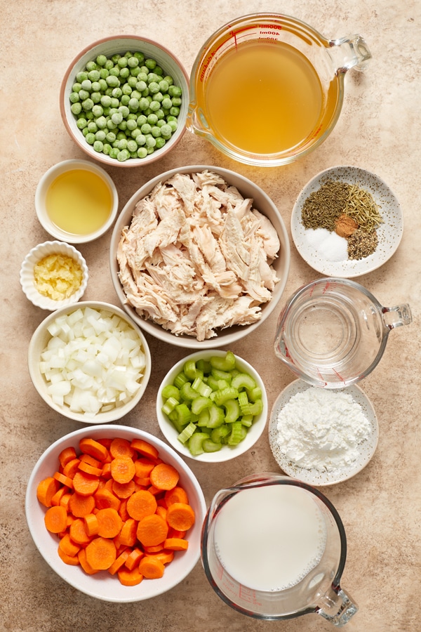 Ingredients for chicken pot pie casserole in small bowls.